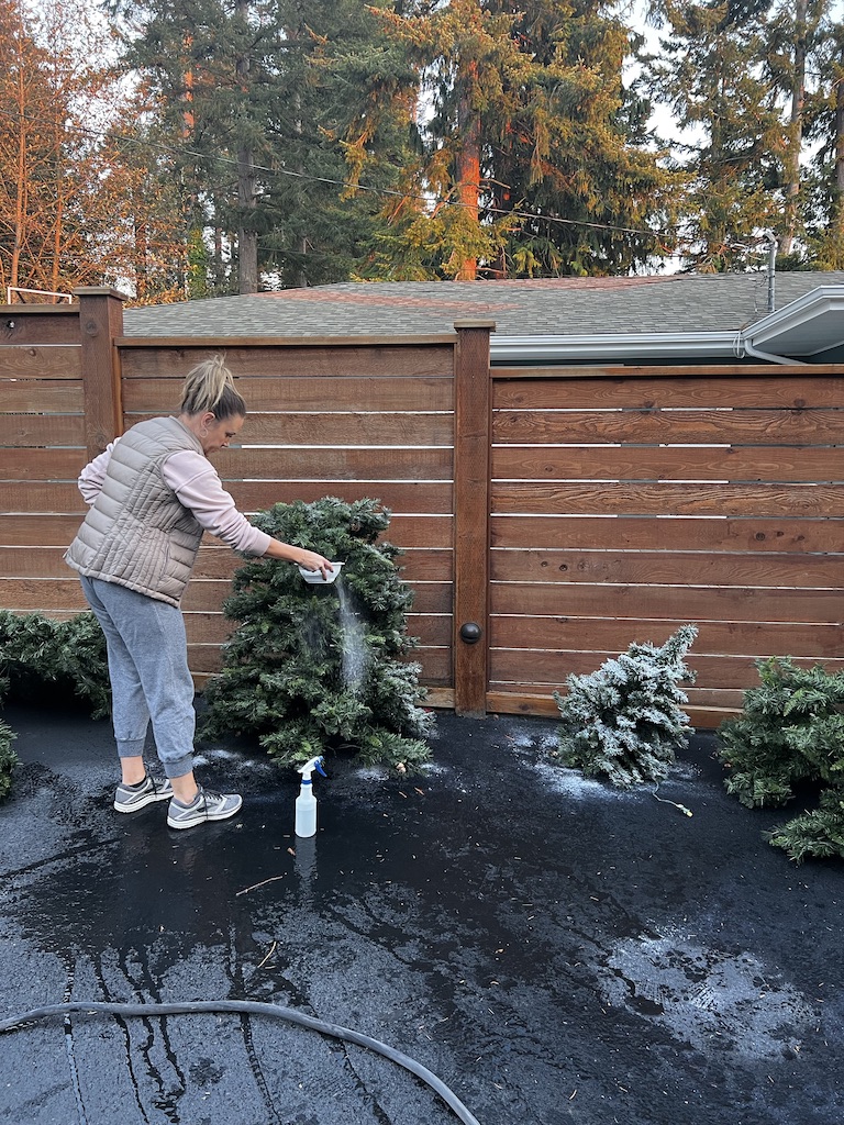 woman adding white paint on Faux Christmas Tree