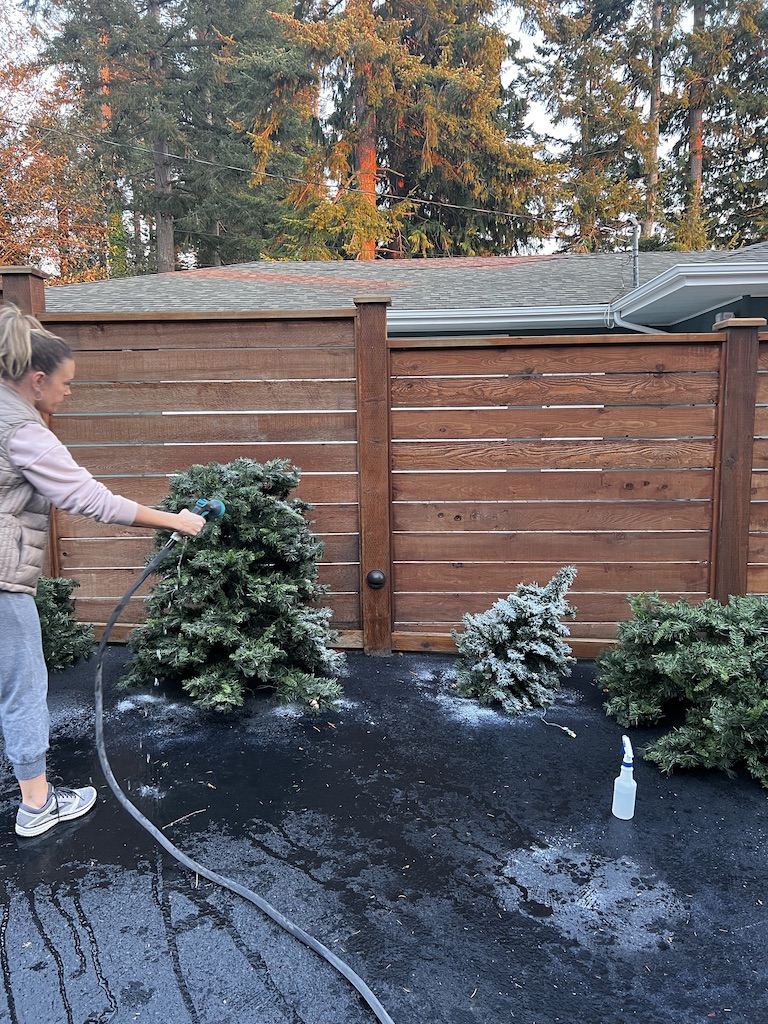 woman cleaning Faux Christmas Tree