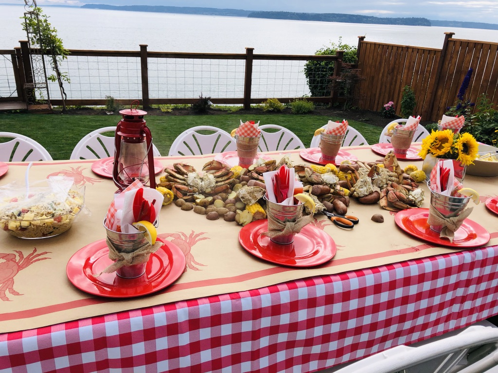 table setting for a long table for a Crab Boil Engagement Party